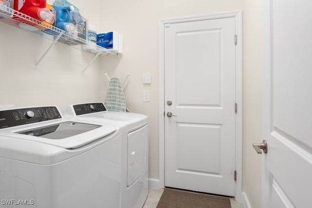 washroom with light tile patterned flooring and separate washer and dryer