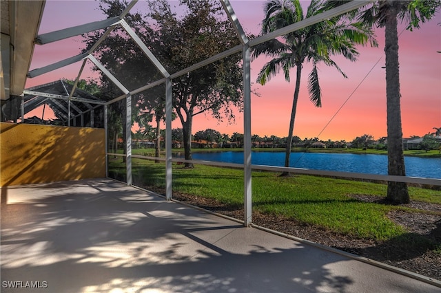 unfurnished sunroom with a water view