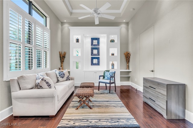 living room featuring ceiling fan, a raised ceiling, and dark hardwood / wood-style flooring