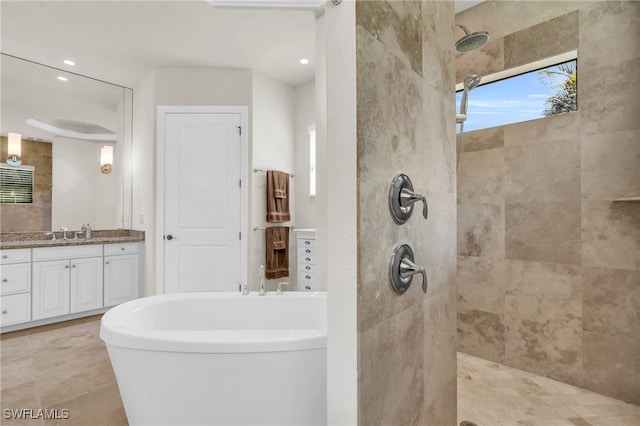 bathroom with vanity, tile patterned flooring, and tiled shower