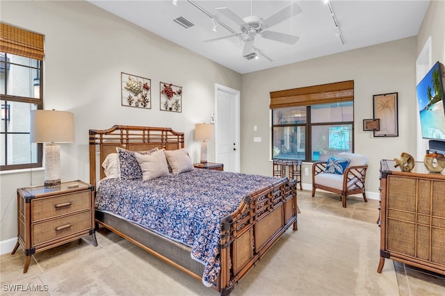 bedroom featuring ceiling fan, light tile patterned floors, and track lighting