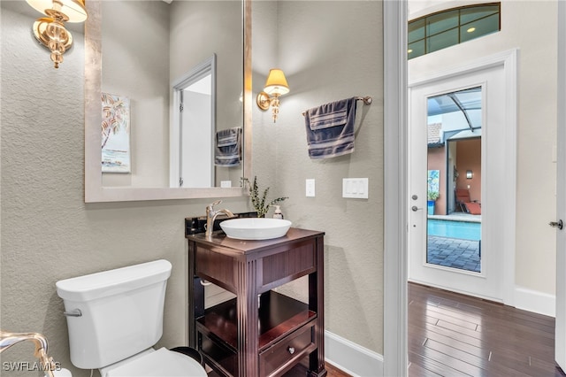 bathroom featuring hardwood / wood-style flooring, vanity, and toilet