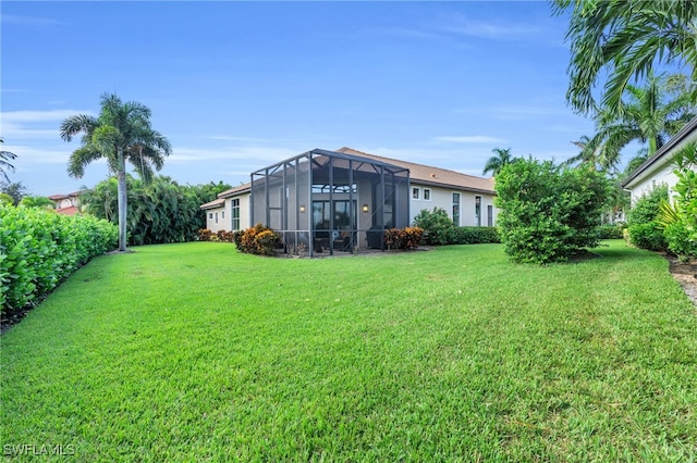 view of yard with glass enclosure