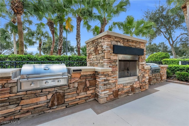 view of patio featuring an outdoor kitchen and a grill