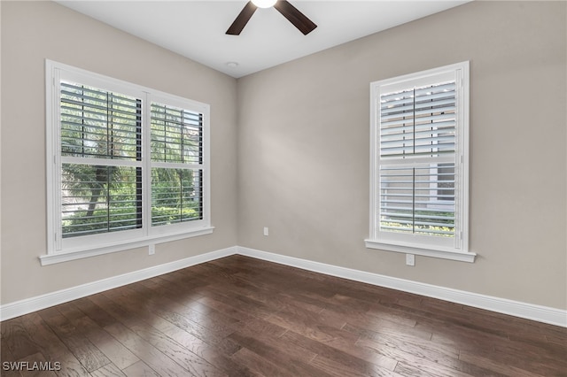 empty room featuring ceiling fan and dark hardwood / wood-style floors