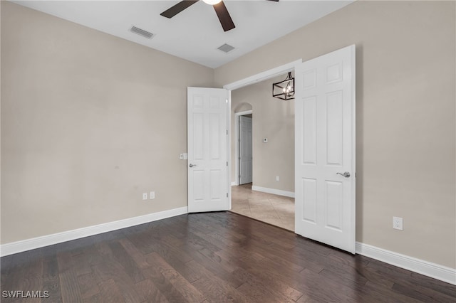 interior space with ceiling fan and dark wood-type flooring