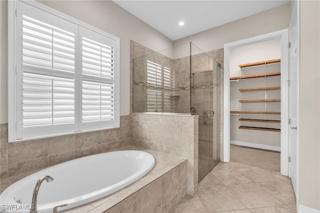 bathroom with separate shower and tub, plenty of natural light, and tile patterned flooring