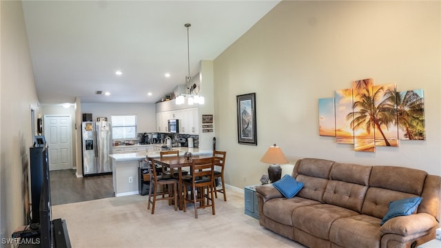 carpeted living room with lofted ceiling