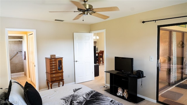 tiled bedroom featuring ensuite bath and ceiling fan