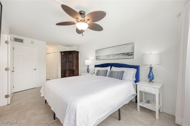 tiled bedroom with ceiling fan