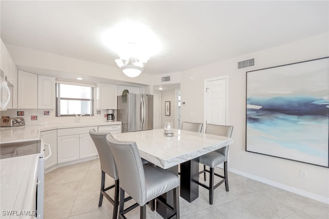 1007 Anglers Cv Unit J204, Marco Island, FL 34145 - dining space with light tile patterned floors and baseboards