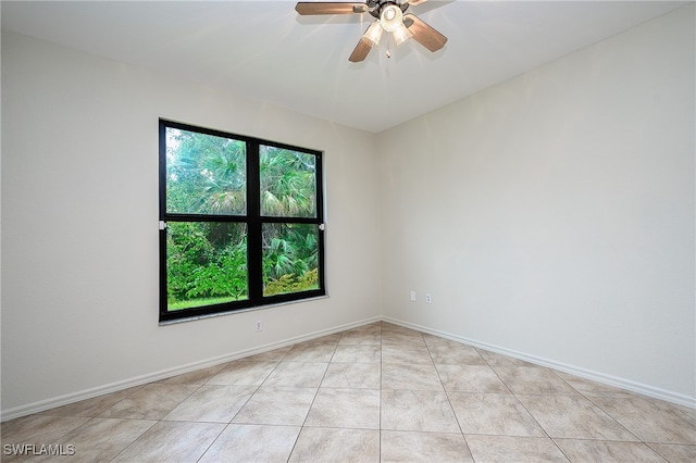 spare room with light tile patterned flooring and ceiling fan