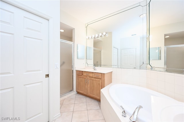 bathroom featuring tile patterned floors, vanity, and shower with separate bathtub