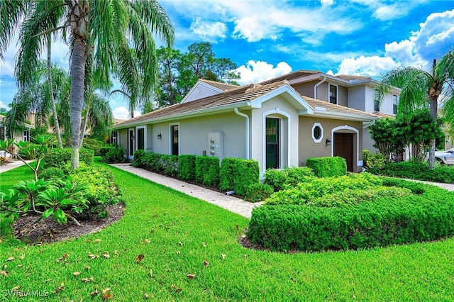 7670 Meadow Lakes Dr Unit 1501, Naples, FL 34104 - view of side of home featuring a lawn and stucco siding