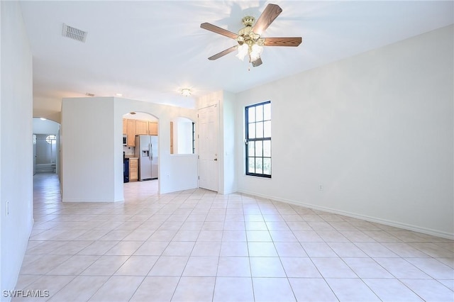 7670 Meadow Lakes Dr Unit 1501, Naples, FL 34104 - spare room with arched walkways, visible vents, ceiling fan, and light tile patterned floors