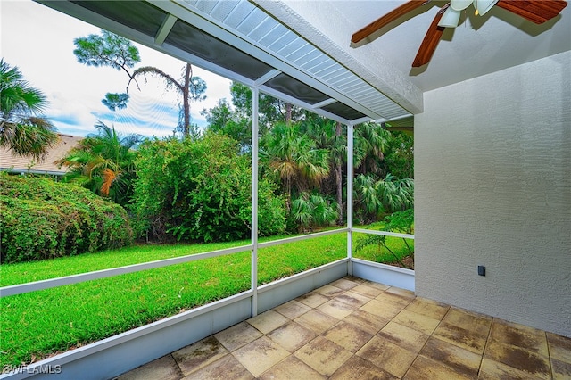 unfurnished sunroom featuring ceiling fan