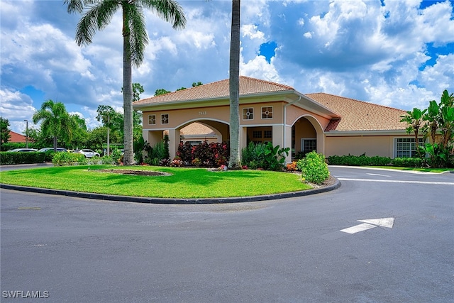 mediterranean / spanish-style house featuring a front yard