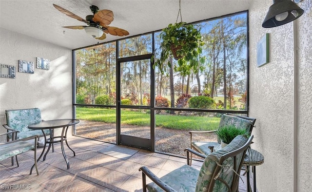 sunroom / solarium featuring ceiling fan