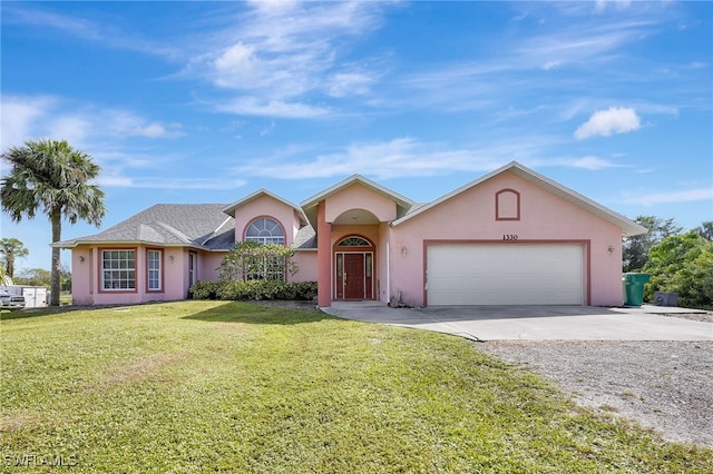 view of front of home featuring a front yard and a garage