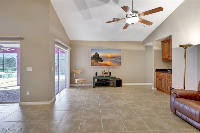 tiled living room with sink, high vaulted ceiling, and ceiling fan