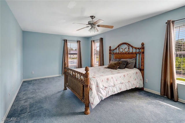 carpeted bedroom featuring multiple windows and ceiling fan