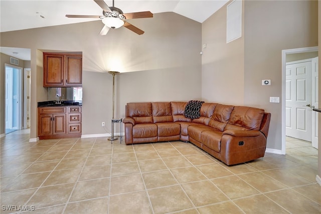 living room featuring sink, ceiling fan, high vaulted ceiling, and light tile patterned floors