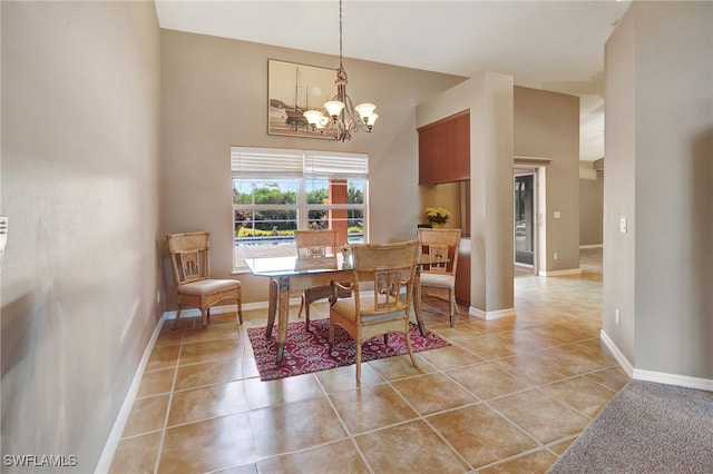 dining area with a notable chandelier, a towering ceiling, and light tile patterned floors