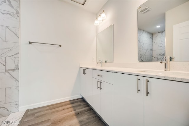 bathroom with hardwood / wood-style floors and vanity