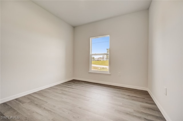 unfurnished room with light hardwood / wood-style floors