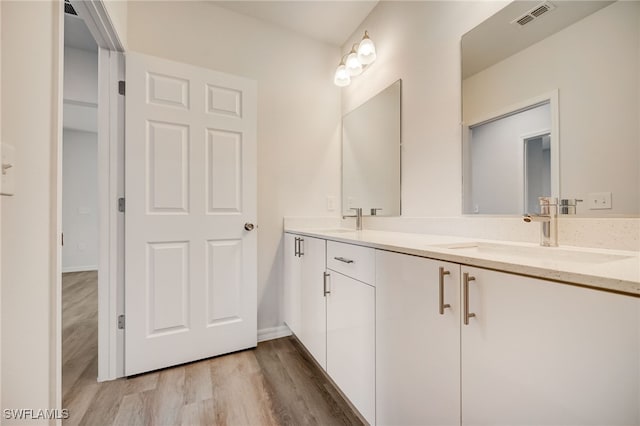 bathroom featuring hardwood / wood-style floors and vanity