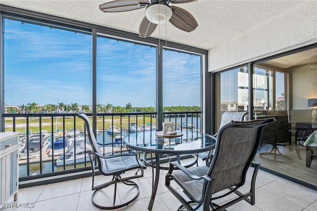 803 River Point Dr Unit 306B, Naples, FL 34102 - sunroom / solarium featuring expansive windows, a textured ceiling, and tile patterned floors