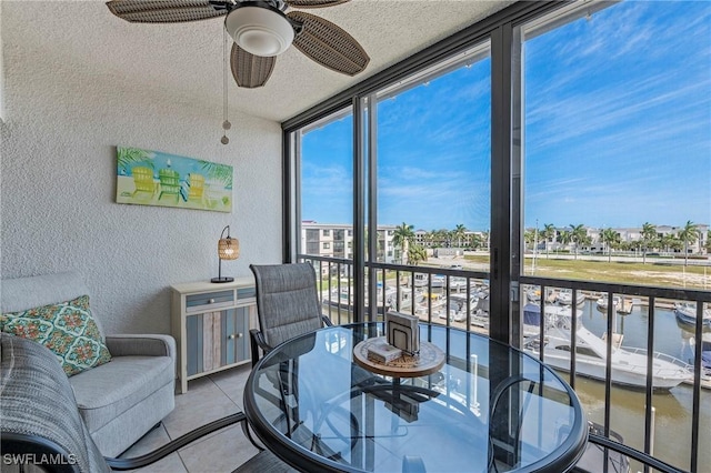 803 River Point Dr Unit 306B, Naples, FL 34102 - sunroom / solarium featuring a textured wall, a wall of windows, tile patterned flooring, a textured ceiling, and a water view