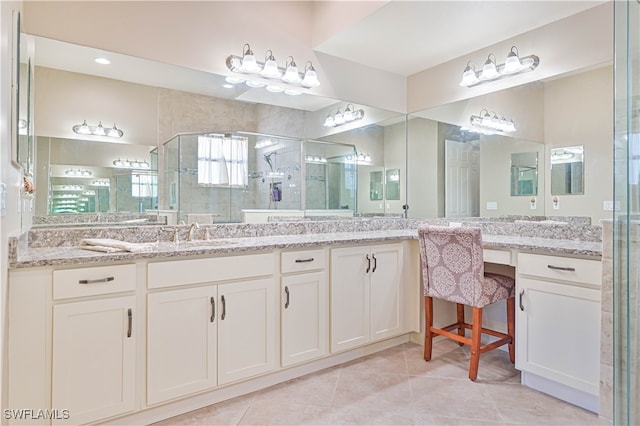 bathroom featuring vanity, walk in shower, and tile patterned flooring