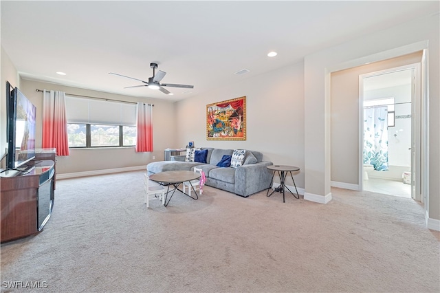 living room with light carpet and ceiling fan