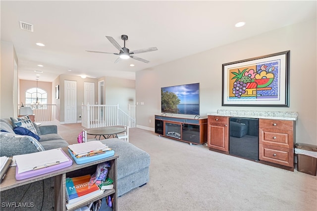 carpeted living room with ceiling fan