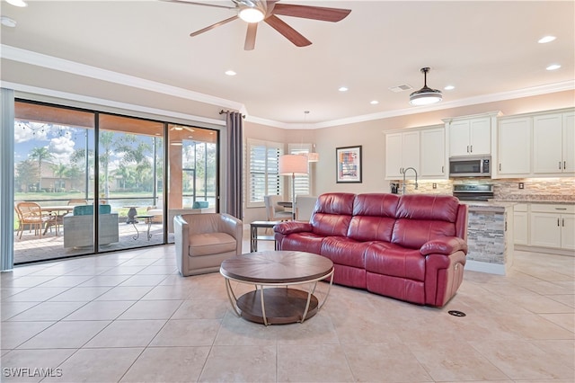 living room featuring ornamental molding, ceiling fan, and light tile patterned floors