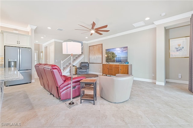 living room with crown molding, light tile patterned flooring, and ceiling fan