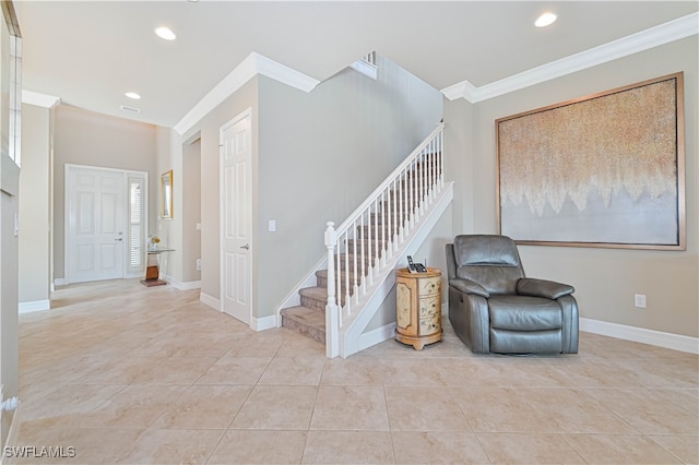 staircase featuring crown molding and tile patterned flooring