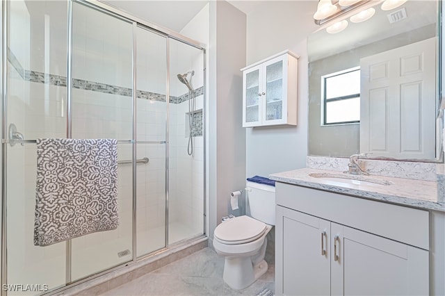 bathroom with toilet, walk in shower, and vanity