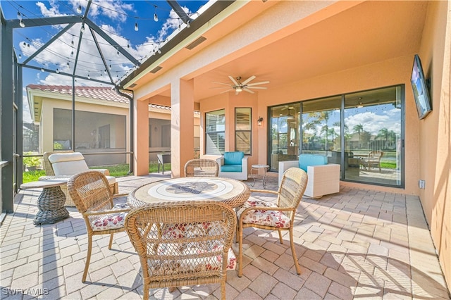 sunroom / solarium featuring ceiling fan