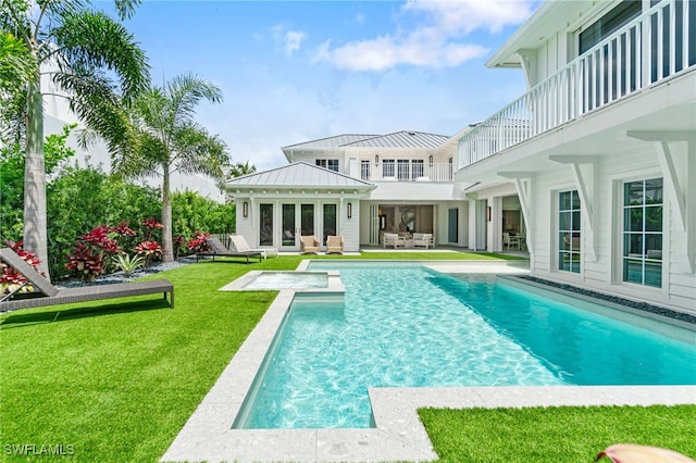 back of house featuring a patio area, a lawn, and a balcony