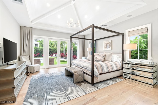 bedroom with multiple windows, a chandelier, beamed ceiling, and light wood-type flooring