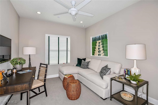 carpeted living room with ceiling fan