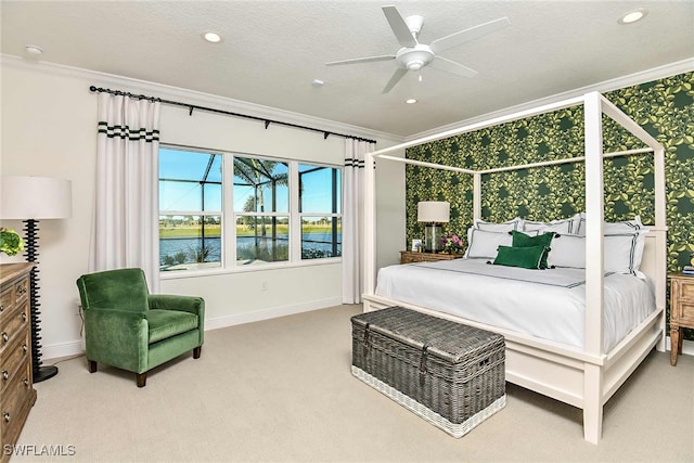 bedroom featuring a water view, ceiling fan, carpet, and a textured ceiling