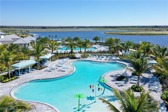 view of pool with a water view and a patio area