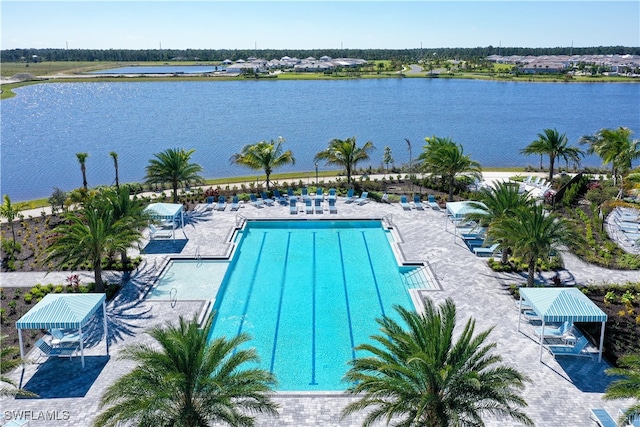 view of pool featuring a water view and a patio