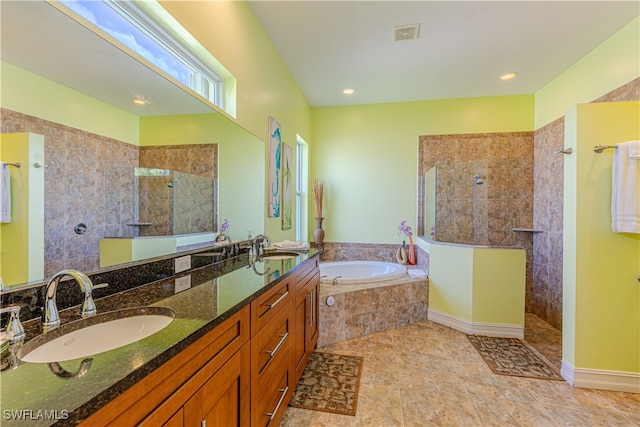 bathroom with tile patterned flooring, plus walk in shower, and vanity