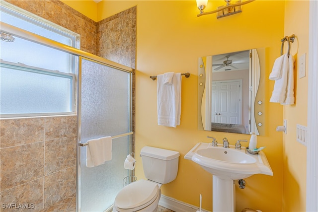 bathroom featuring an enclosed shower, ceiling fan, and toilet