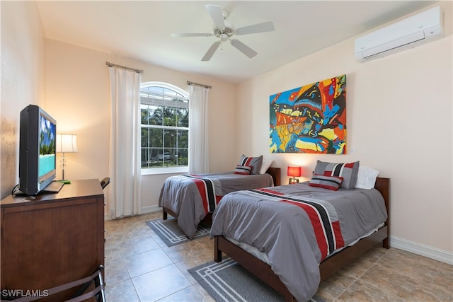 tiled bedroom with a wall unit AC and ceiling fan