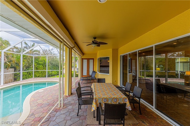 exterior space featuring glass enclosure and ceiling fan